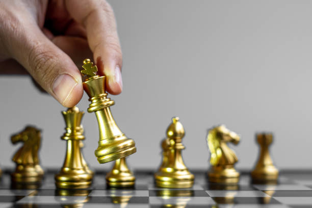 istock gold Chess king figure Stand out from the crowd on Chessboard background. Strategy, leadership, business, teamwork, different, Unique and Human resource management concept 1319461400