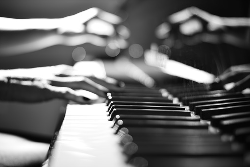Defocused picture of piano playing hands
