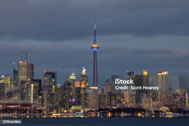 A Cloudy Sky Above The Toronto Skyline With Golden Light Hitting The Skyscrapers Stock Photo - Download Image Now