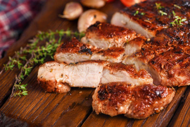 istock Sliced fried pork steak on a wooden board for serving 1319464904