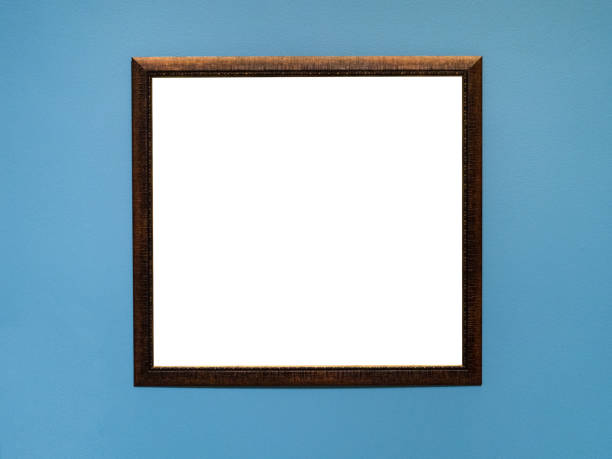 istock narrow brown flat wood picture frame on blue wall 1319465648