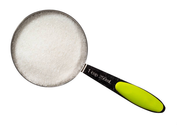 istock refined white sugar from in measuring cup cutout 1319466674