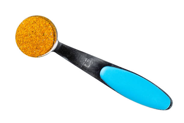 ground Marigold Flowers in measuring spoon cutout top view of ground Imeretian Saffron (Dried Marigold Flowers) in measuring teaspoon cutout on white background substitute for saffron stock pictures, royalty-free photos & images