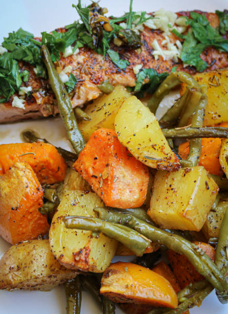 istock Grilled salmon with baked potatoes and vegetables 1319467649
