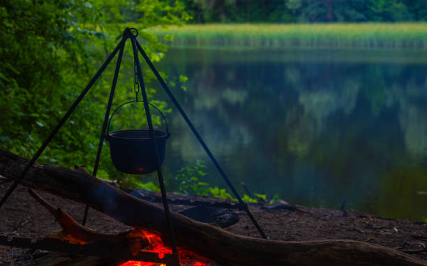 istock The kettle basks over a bonfire on the riverbank. 1319468517