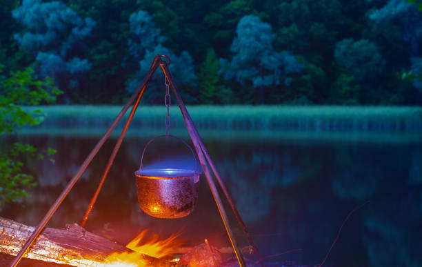 istock The kettle basks over a bonfire on the riverbank. 1319468536