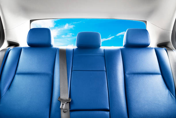 Back passenger red leather seats in modern luxury car. Blue perforated leather with stitching. Car inside. Leather comfortable blue seats. Car interior details