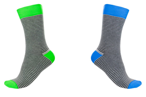 istock Two volumetric socks with different lines isolated on white background. Colorful volumetric socks on white background. Colored socks on the leg isolated on white background 1319469823