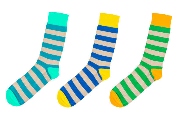 istock Three socks with different lines isolated on white background. Colorful socks son white background. Colored socks on the leg isolated on white background 1319469965