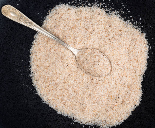 top view of silver teaspoon in Psyllium husk on black top view of silver teaspoon in Psyllium husk on black plate tsp stock pictures, royalty-free photos & images