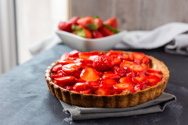 istock delicious strawberry cake on black background 1319471839