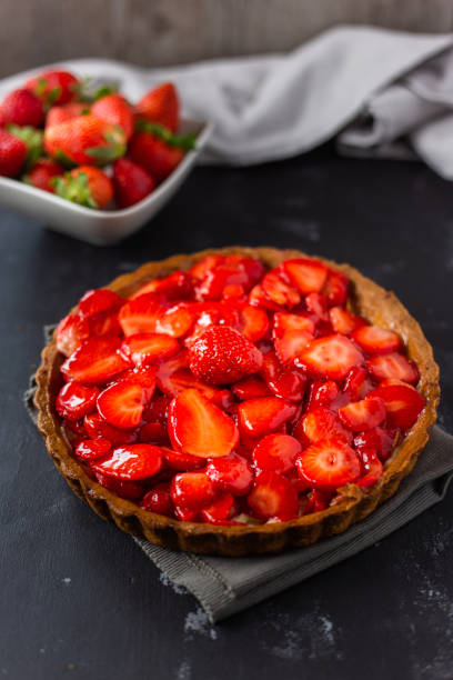 istock delicious strawberry cake on black background 1319471852