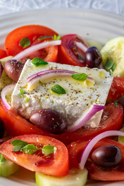 istock Greek salad on white serving plate. 1319472999
