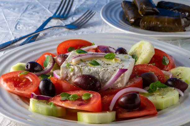 istock Greek salad on white serving plate. 1319473040