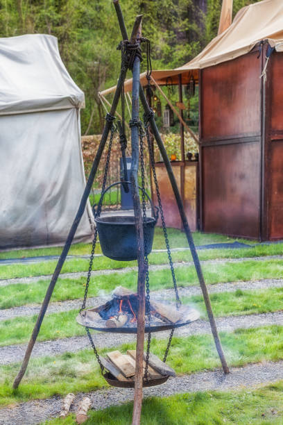 istock Medieval hearth on a wooden tripod. 1319474525