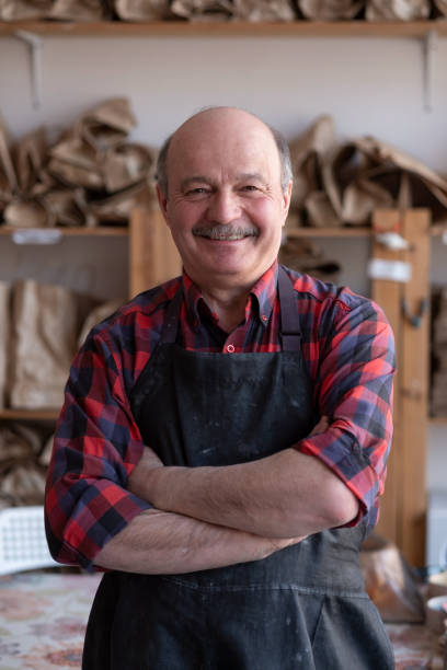 istock Senior happy hispanic craftsman standing in studio. 1319474698