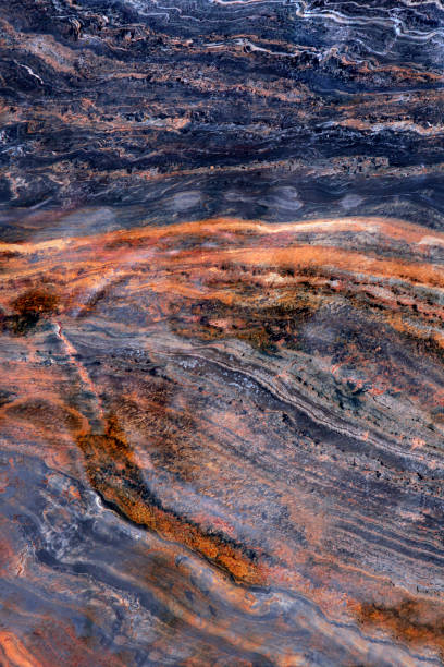 istock Folda Quartsite stone texture vertical image. Colorful surface with stripes, Polished metamorphic Stone Background, abstract stone surface with curved stripes. Foun in Norway mountains 1319475400