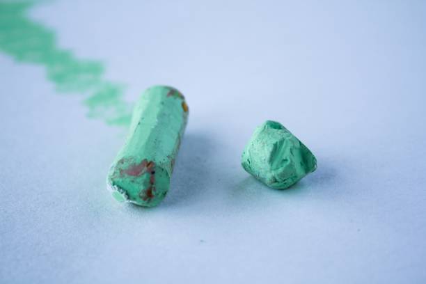 istock Green chalk on the white background 1319475743
