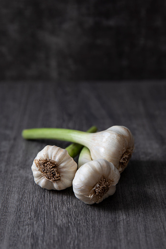 Bunch of fresh garlic on dark wooden surface