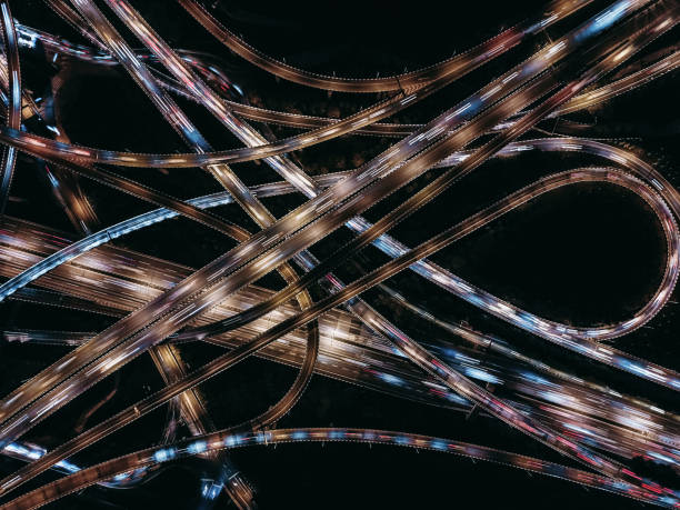 istock Aerial View of Complex Overpass and Busy Traffic at Night 1319478048