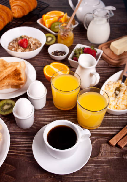 istock Cup of coffee, juice, eggs, fruits, toasts. Breakfast concept. 1319479210
