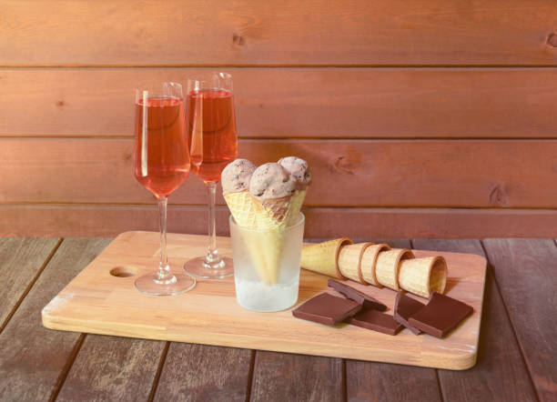 istock Rose champagne, chocolate ice cream, dark chocolate  and empty waffle cones.  Selective focus. 1319479272