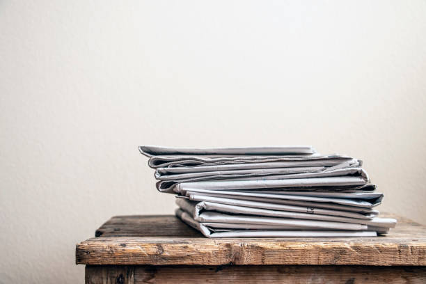 istock Old newspapers on wooden table 1319479446