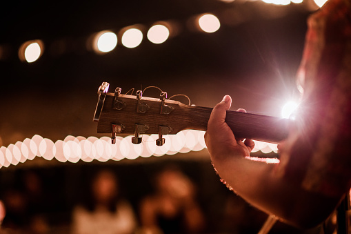 Musicians playing guitar at music festivals, lights,  music, concerts, mini concerts. music festivals