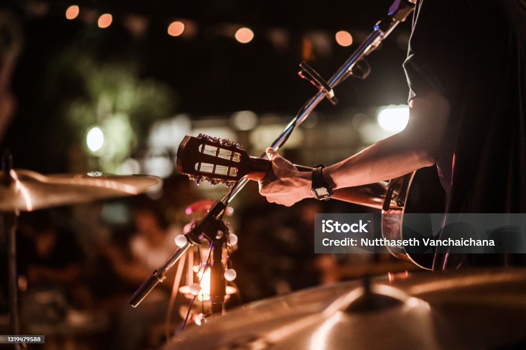 The musicians were playing rock music on stage, there was an audience full of people watching the concert. Concert,mini concert and music festivals. Music Festival Stock Photo
