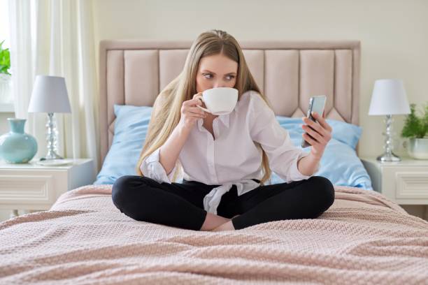 istock Happy talking young woman using video communication on smartphone 1319480619