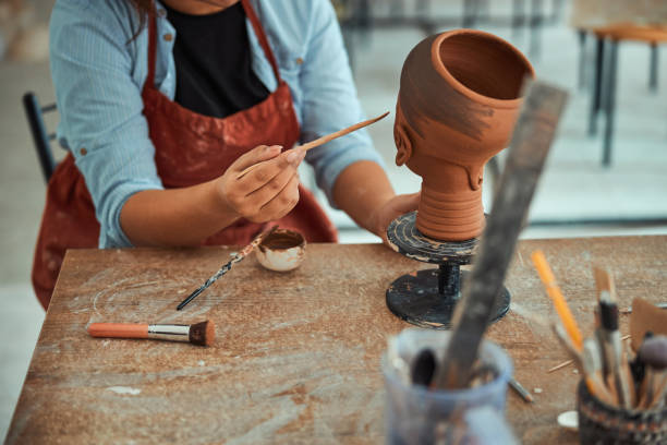 istock Female ceramic artist working in pottery workshop 1319481637