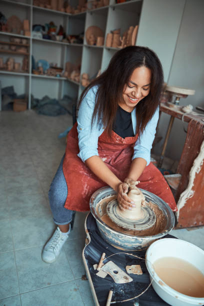 istock Joyful female ceramist making pottery in workshop 1319481657