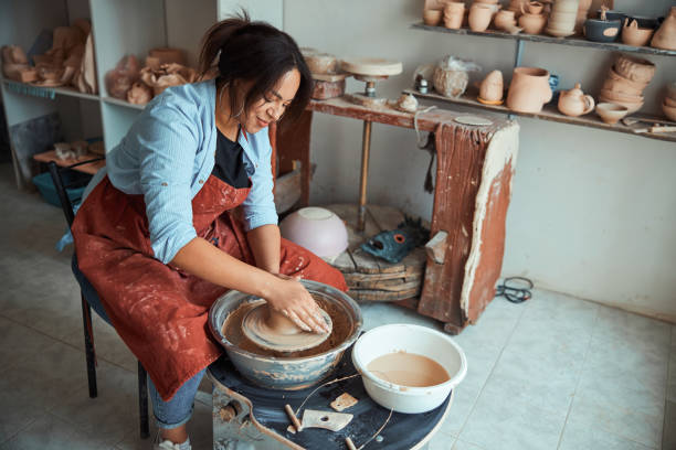 istock Charming female ceramist making pottery in workshop 1319481679