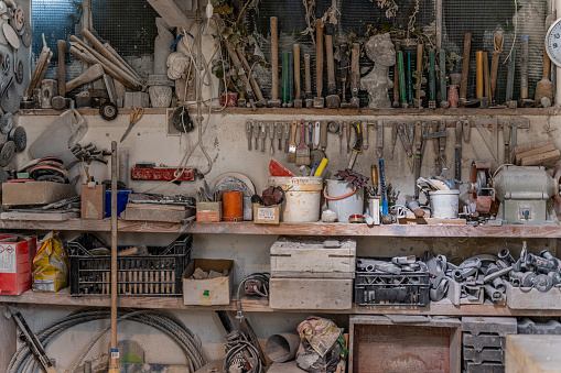 Different tools on shelves in a stonemason's workshop.