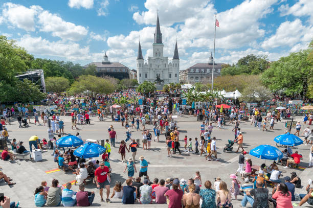 Jackson Square in New Orleans and Catheral with People During the French Quarter Festival NEW ORLEANS, LOUISIANA - APRIL 10, 2016: Jackson Square in New Orleans and Catheral with People During the French Quarter Festival jackson square stock pictures, royalty-free photos & images
