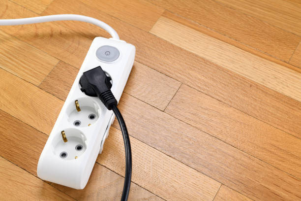 istock White extension cord with three outlets. Power strip with switch for home or office. 1319482919