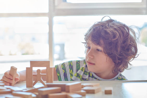 istock Cute little boy Playing with Wooden Blocks 1319482956