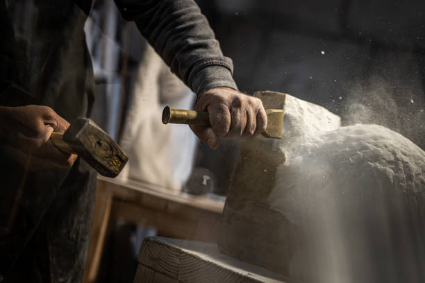 istock Stonemason chiseling his sculpture 1319483941