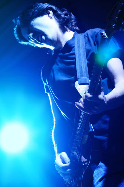 istock Young man plays electric guitar 1319484224