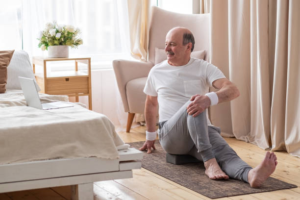 istock Senior caucasian man doing yoga Spine twisting pose 1319484517