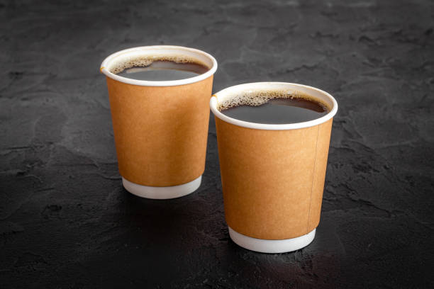 istock Take out coffee in paper cups on the table. Close up 1319485669