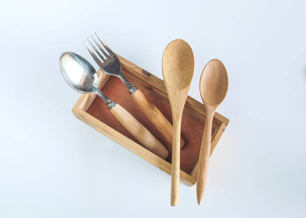 Set of wood foodware in box on background.
