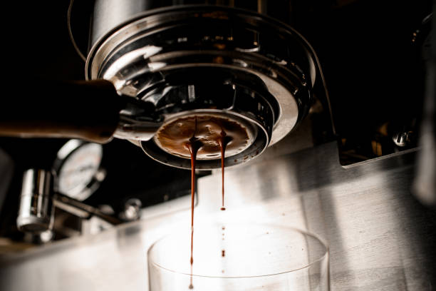 istock bottom view on portafilter of coffee machine from which espresso flows into glass 1319490307