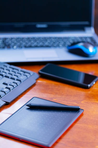 istock Remote work graphic designer. Freelancer workplace. Laptop, smartphone and graphic tablet in the workplace 1319493697