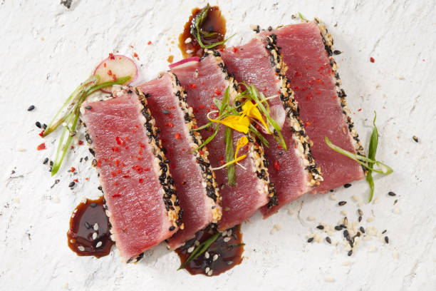 Ahi Tuna Tataki with a Soy Vinaigrette , Green Onions, Korean Chili Powder and Edible Flowers