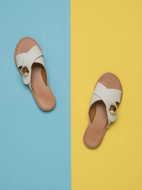 istock Women's summer sandals on a light yellow and blue background. 1319493920