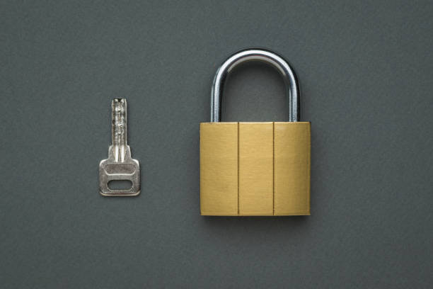 istock Closed classic lock and key on a gray background. Flat lay. 1319493931