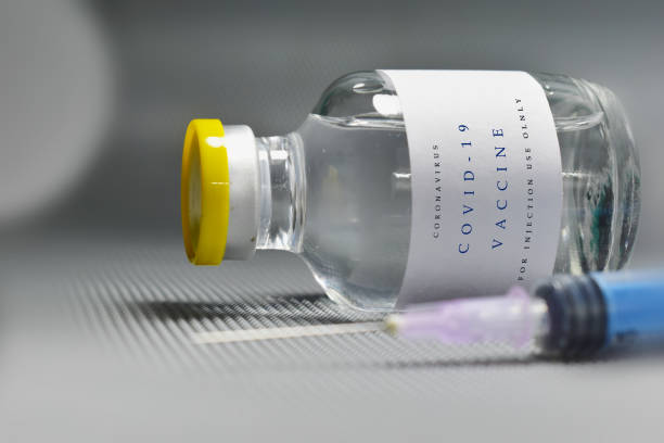 istock Corona virus vaccine bottle with syringe 1319495977