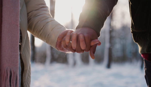 istock holding hands in the park 1319496179