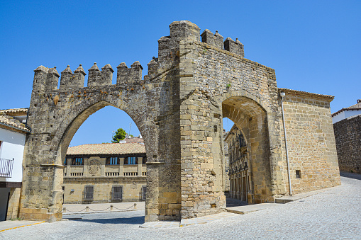 Gate of Jaén and arch of Villalar in the Plaza de Populo in the medieval city of Baeza, province of Jaén. Spain